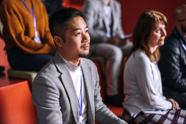 istock Young well dressed asian man attending business conference 1382270430