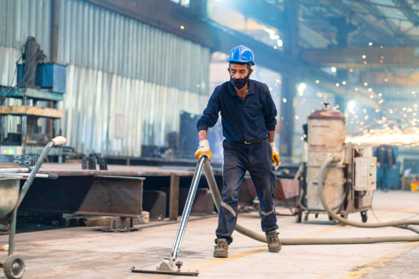 metalworker using vacuum cleaner metalworker using vacuum cleaner working seniors stock pictures, royalty-free photos & images