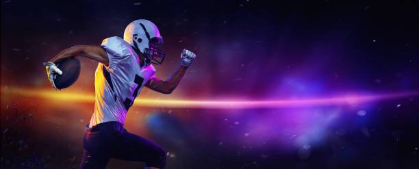 Dynamic portrait of male american football player in sports equipment at stadium in motion on dark background with mixed neon light. Collage, poster stock photo