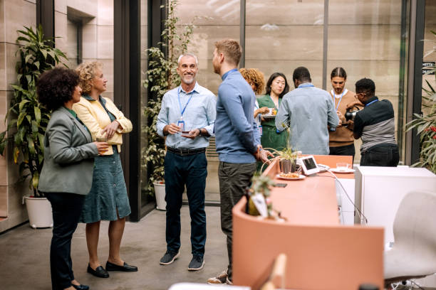 group of business people having casual conversation while on a refreshment break - business conference meeting teamwork imagens e fotografias de stock