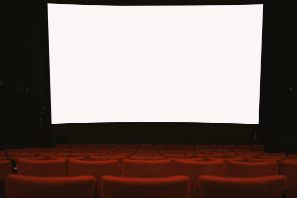 istock Movie theatre with empty armchairs and empty movie screen 1382271436