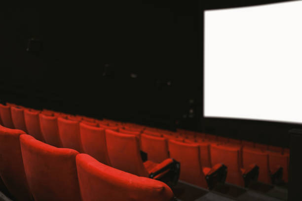 istock Movie theatre with empty armchairs and empty movie screen 1382271438