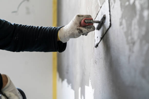 istock Close up of human hands working on concrete wall texture 1382271718
