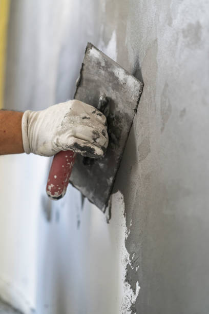 istock Close up of human hands working on concrete wall texture 1382271831