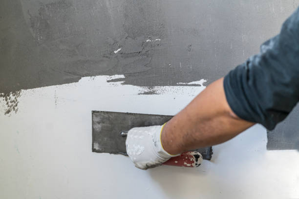 istock Close up of human hands working on concrete wall texture 1382271847