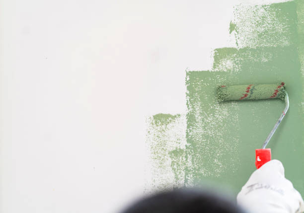 istock Mature man painting wall in apartment 1382271993