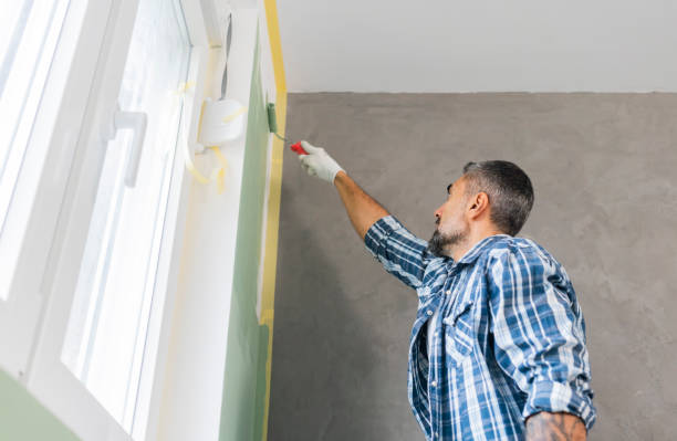 istock Mature man painting wall in apartment 1382272038