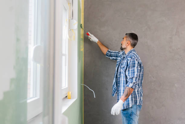 istock Mature man painting wall in apartment 1382272055