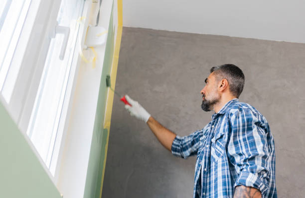 istock Mature man painting wall in apartment 1382272088