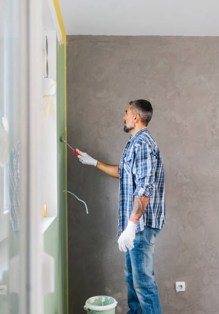 istock Mature man painting wall in apartment 1382272105