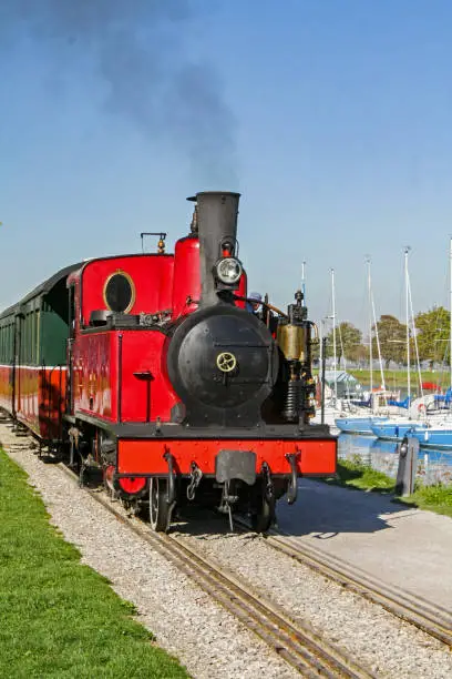 Photo of Saint-Valéry-sur-Somme. Tourist train along the marina. Sum. Picardy. Hauts-de-France