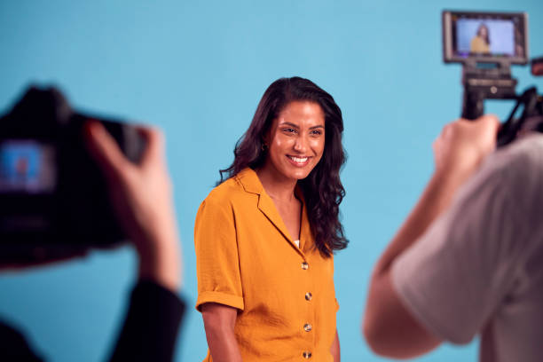 istock Mature Woman In Studio On Shoot With Video And Stills Camera 1382273088