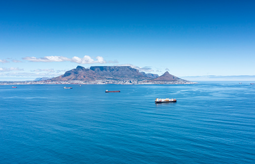 Aerial view of freight vessels waiting to offload in Table Bay harbour, Cape Town, South Africa