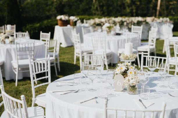 istock Wedding. Banquet. Chairs and honeymooners table decorated with candles. 1382273220