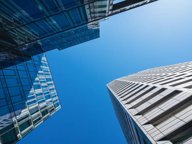 istock Bottom-up view of modern skyscrapers over blue sky background 1382273875