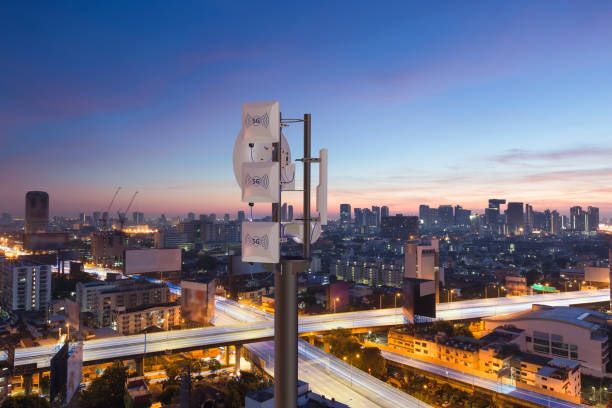istock Telecommunication tower with 5G cellular network antenna on night city background 1382274901