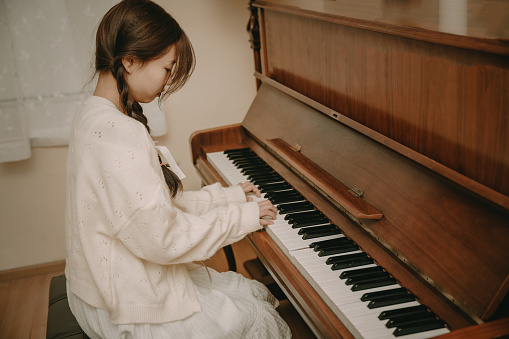 A beautiful asian girl playing the piano
