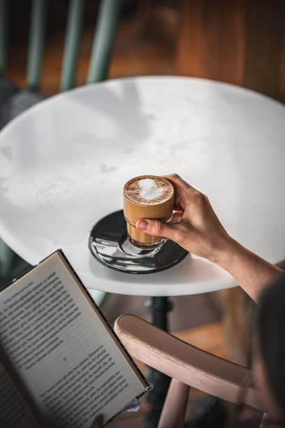 istock Woman drinking coffee and reading a book 1382274943