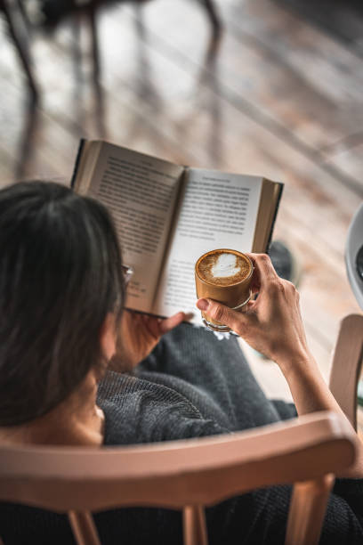 istock Woman drinking coffee and reading a book 1382274998