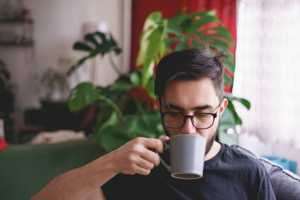 istock Young man enjoying his coffee at home 1382275120