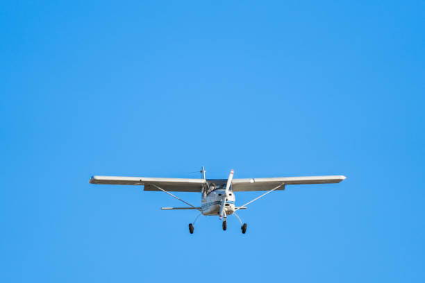 istock Small plane flying head-on in a clear blue sky 1382275218