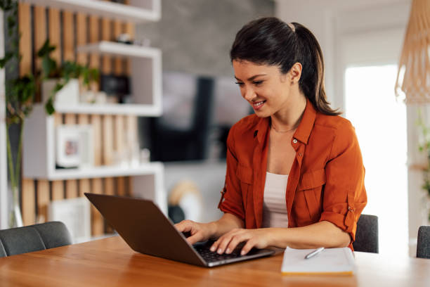 istock Cheerful caucasian woman, checking her e-mails, on her laptop. 1382275304
