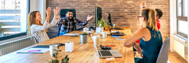 istock Businesspeople celebrating a success in office 1382275365