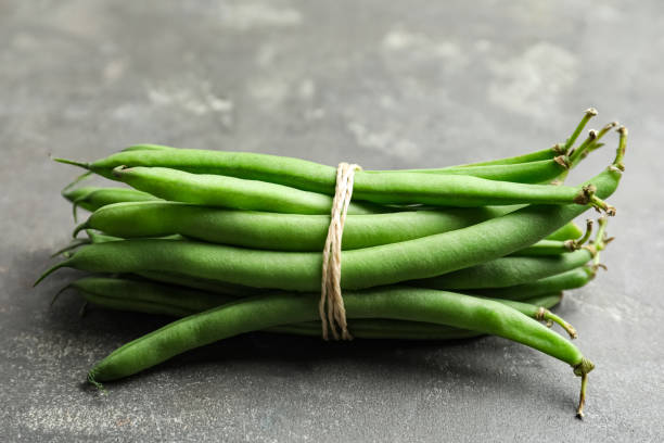 istock Fresh green beans on grey table, closeup 1382278199