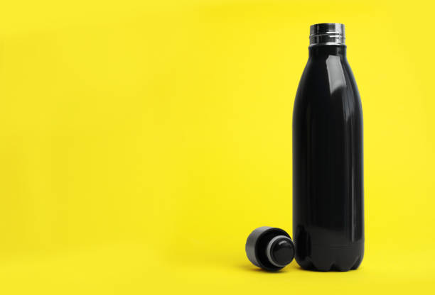 istock Stylish thermo bottle on yellow background, space for text 1382278535