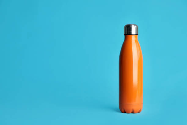 istock Stylish thermo bottle on light blue background, space for text 1382278837