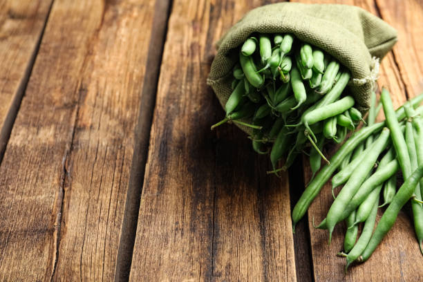 istock Fresh green beans on wooden table. Space for text 1382281148