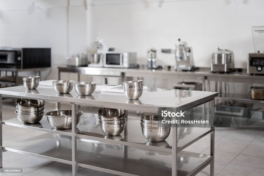 Professional restaurant kitchen with kitchen equipment Professional restaurant kitchen with kitchen equipment and stainless steel tables. Interior with no people Stainless Steel Stock Photo