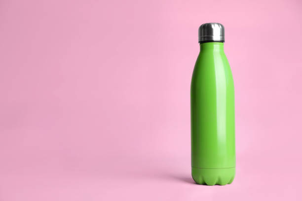 istock Stylish thermo bottle on pink background, space for text 1382284173