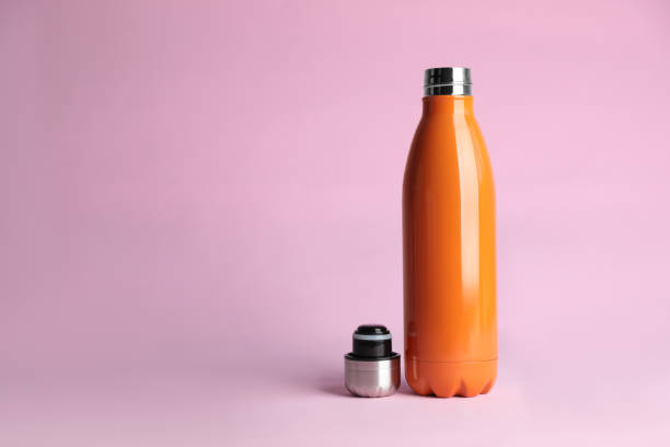 istock Stylish thermo bottle on pink background, space for text 1382284174