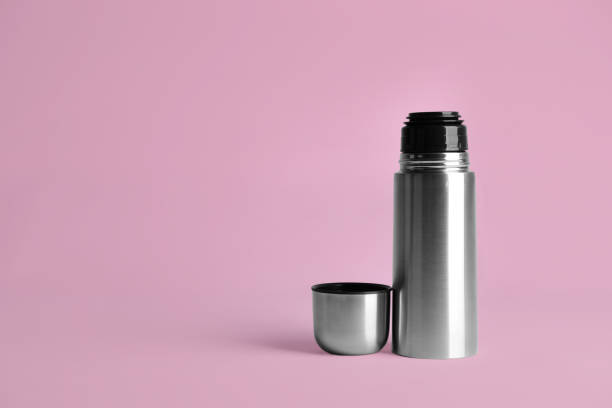 istock Stylish thermo bottle on pink background, space for text 1382284194