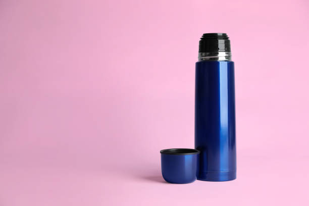 istock Stylish thermo bottle on pink background, space for text 1382285294