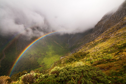 Rainbow over the valley between Mintaro Hutt and Mackinnon Pass, Milford Track Fiordland National Park, New Zealand