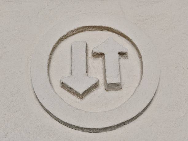 istock Arrow Opposite Directiont Sign Made From The Sand 1382288457