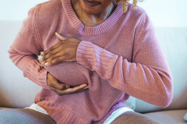 istock Mature woman doing self breast exam at home 1382292108
