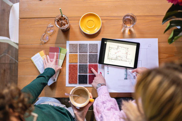 istock High angle view of unrecognizable female architect and interior designer, together working on a new project 1382292111