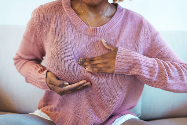 Breast cancer. Breast cancer. Young african woman feeling menstrual cyclic breast pain, touching her chest, cropped. Close-up Of A Woman's Hand On Breast Showing Cancer Symptom bumpy stock pictures, royalty-free photos & images