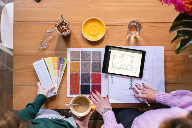Unrecognizable female architect and interior designer, together working on a new project from the modern coffee shop