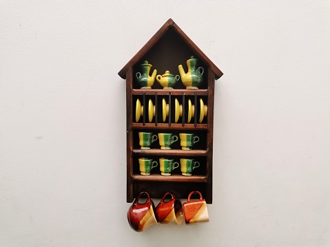 mini porcelain tableware on a wooden shelf, decorative object