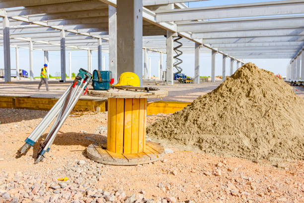 Protective construction helmet and iron rods on a public road reconstruction.