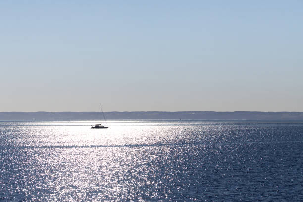 istock Single sail boat on a blue calm sea under blue sky, Halmstad, Sweden 1382293536