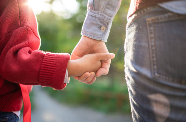 istock Daughter and mother's holding hands 1382293855