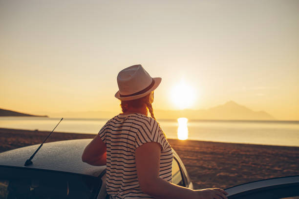 istock Pregnant woman watching the sunset on a beach 1382294501