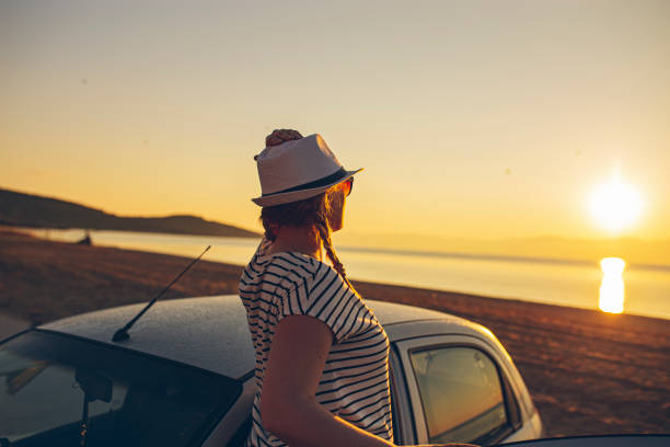istock Pregnant woman watching the sunset on a beach 1382294518