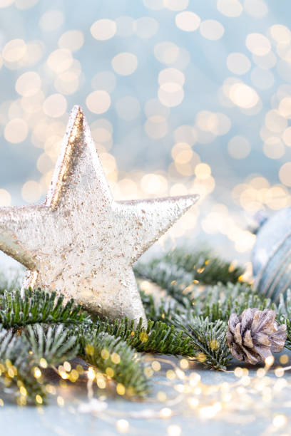 istock Christmas spruce with star and blurred shiny lights. 1382294852