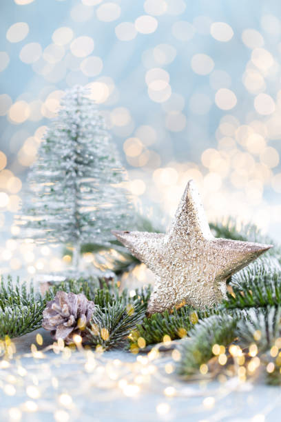 istock Christmas spruce with star and blurred shiny lights. 1382295439